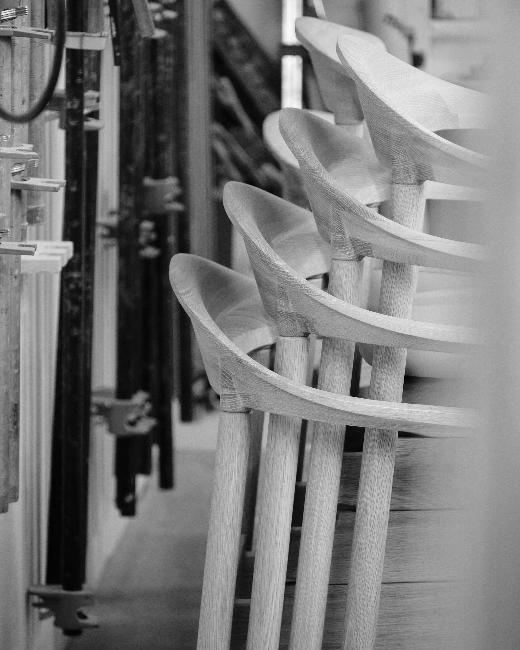 a sideview of a stack of Dune chairs in the woodshop